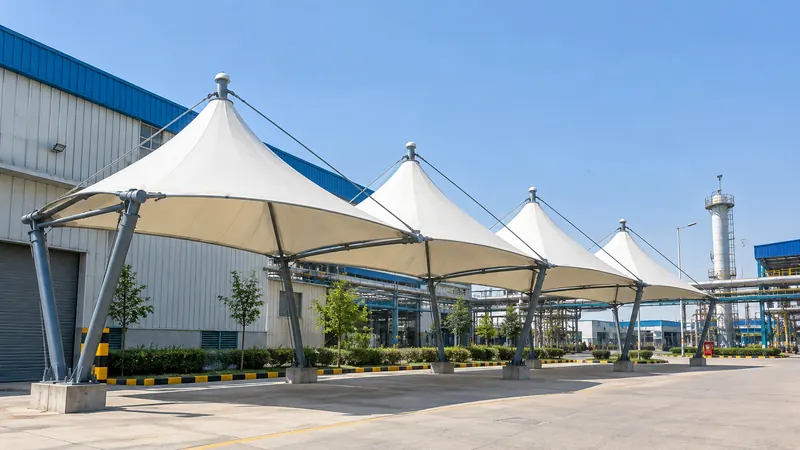 Row of four conical tensile canopies at an industrial plant