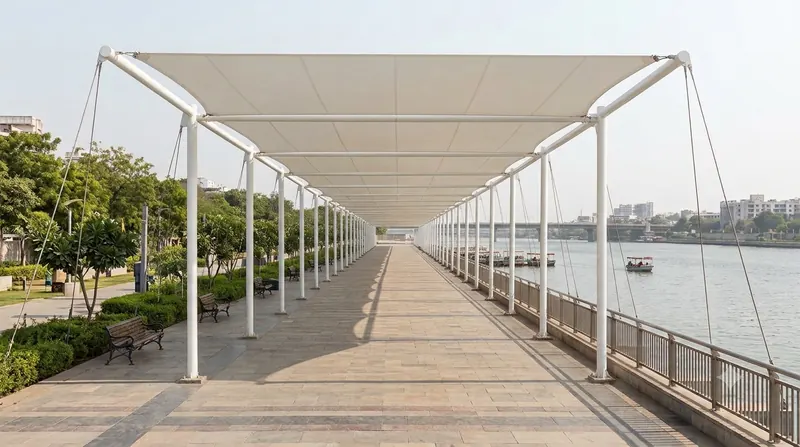 Tensile walkway canopy running along a riverfront promenade