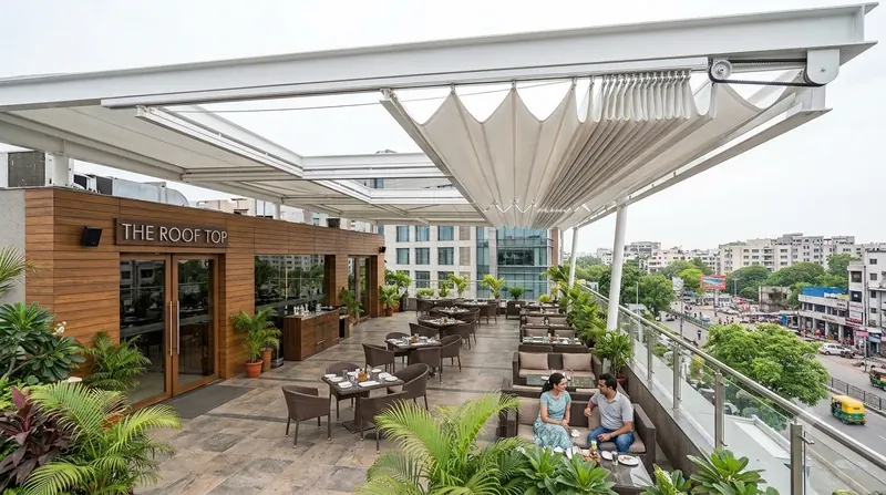 Retractable folding fabric roof over a rooftop restaurant terrace